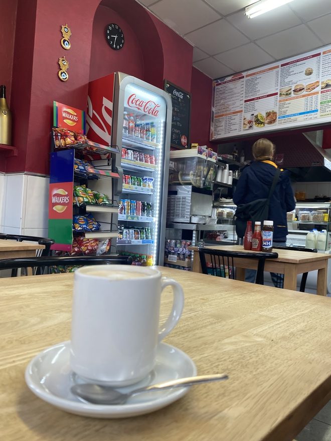 The cafe interior seen from a table, counter beyond
