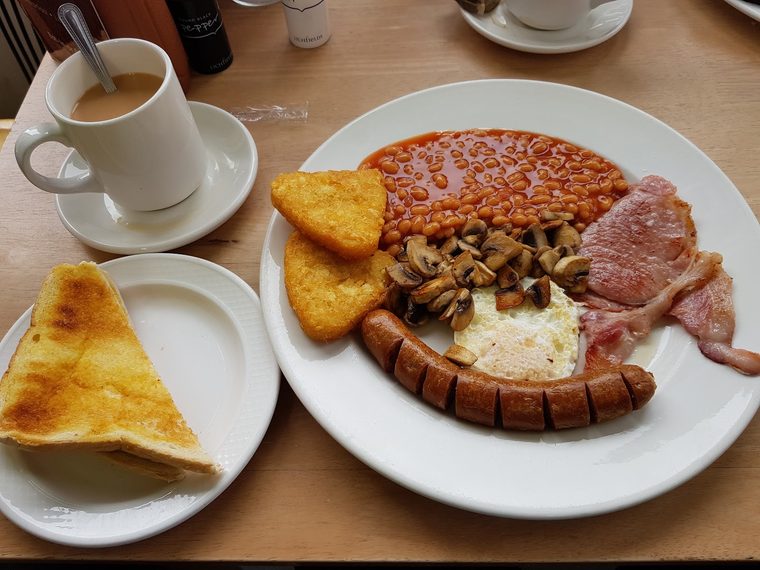 Full English breakfast with buttered toast and a mug of tea