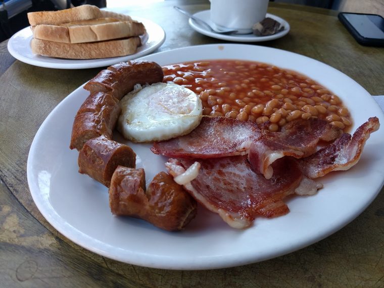 Bacon, sausage, beans and fried egg with toast